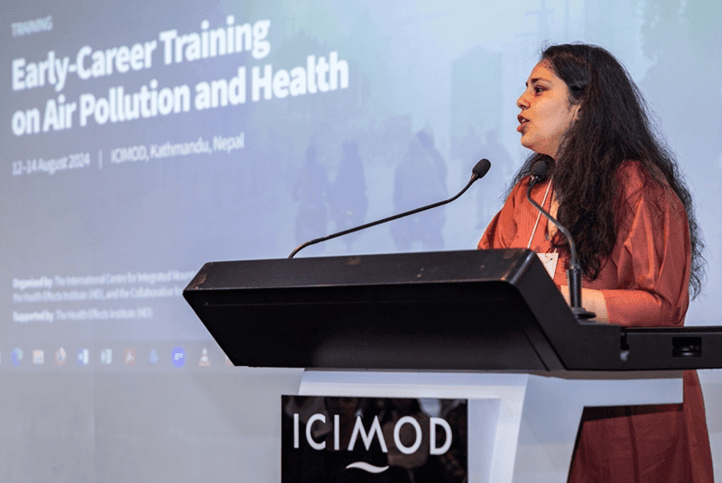 Pallavi Pant speaking at podium with ICIMOD sign on it